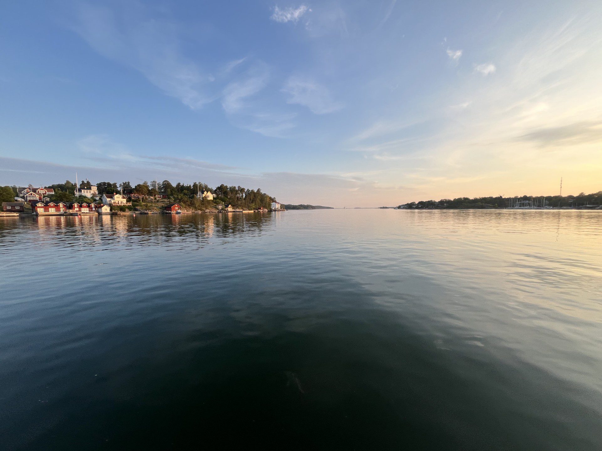Köpmanholm (Roslagen) - Sunset view of the Stockholm archipelago with calm Baltic Sea, islands and waterfront houses, experienced during a private RIB charter boat tour with 59 DEGREES NORTH.